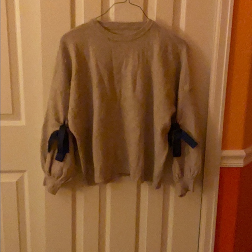 Tan Sweater With Blue Bows in the Sleeves